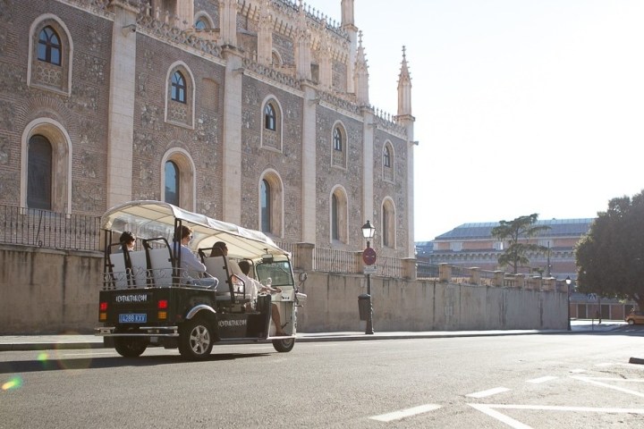 a person riding a skateboard down a street in front of a building