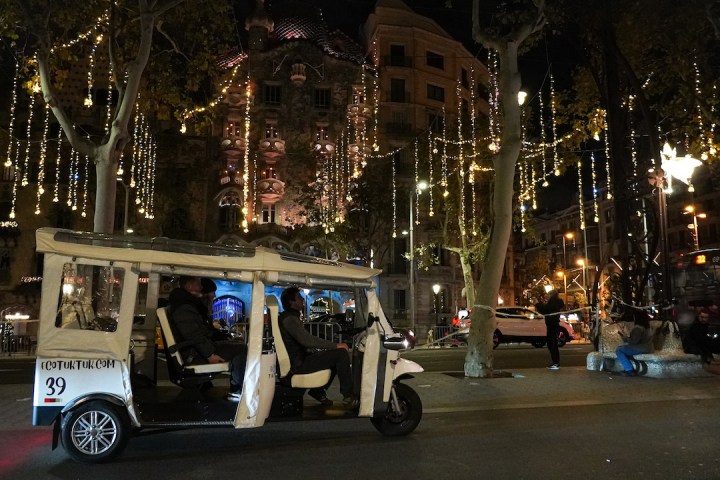a person riding a motorcycle on a city street at night