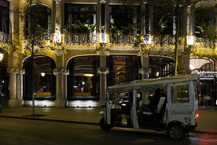 a group of people on a stage in front of a building