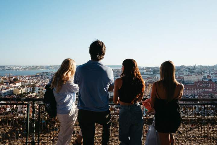 a woman standing in front of a fence
