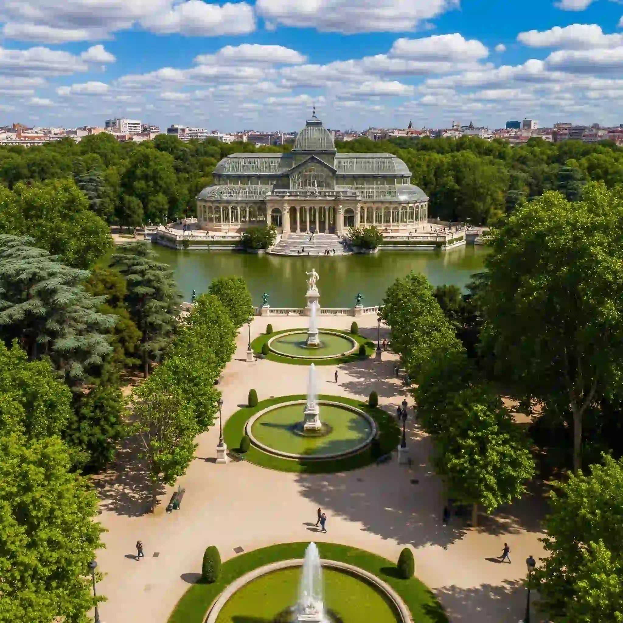 El Retiro Park a castle with blue and green bushes in El Retiro Park